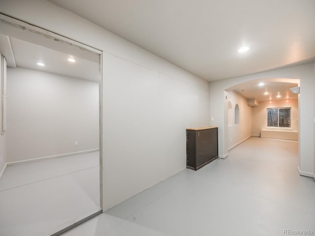 unfurnished room with concrete flooring