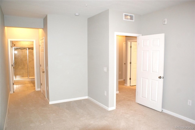 unfurnished bedroom with light colored carpet