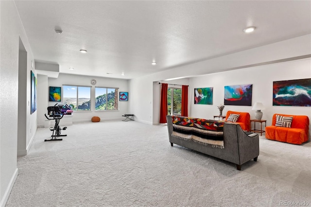 living room featuring light colored carpet and a textured ceiling