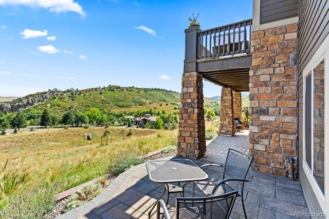 view of patio featuring a balcony