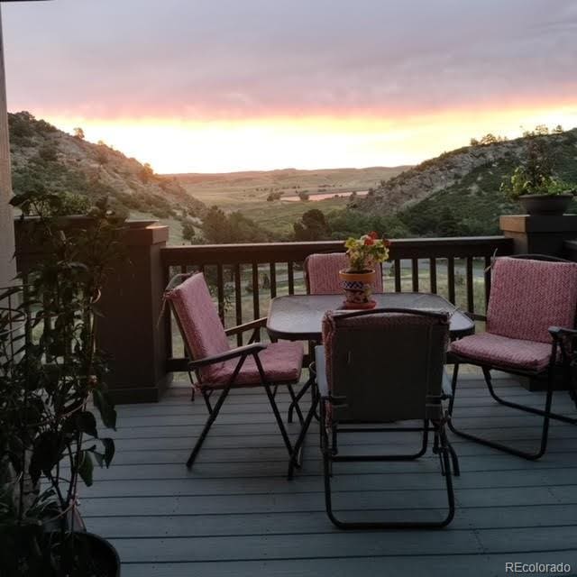 deck at dusk featuring a mountain view