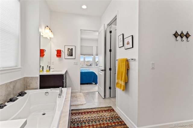 bathroom featuring a tub to relax in, tile patterned flooring, and vanity