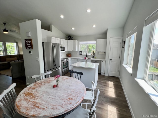 4178 E 94th Pl, Thornton, CO 80229 - dining room featuring lofted ceiling, dark wood-style floors, recessed lighting, baseboards, and a ceiling fan
