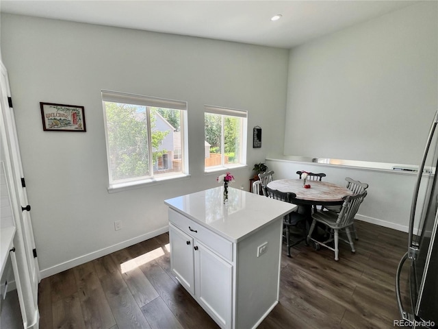 4178 E 94th Pl, Thornton, CO 80229 - kitchen with dark wood-type flooring, white cabinetry, baseboards, recessed lighting, and freestanding refrigerator