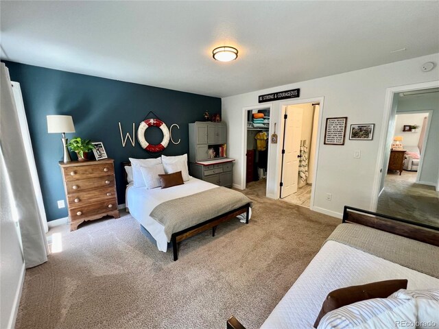4178 E 94th Pl, Thornton, CO 80229 - bedroom featuring light colored carpet, a walk in closet, and baseboards