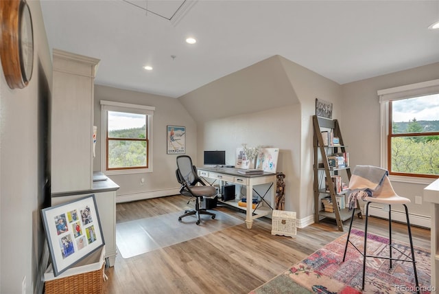 office space featuring recessed lighting, wood finished floors, baseboard heating, baseboards, and a baseboard heating unit