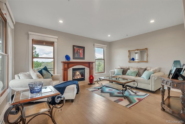 living area with recessed lighting, wood finished floors, and a fireplace