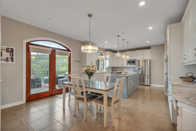 dining space with recessed lighting, baseboards, and light tile patterned floors