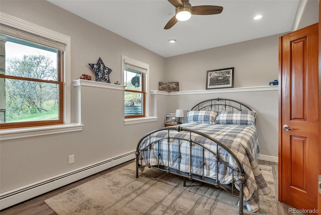 bedroom featuring baseboard heating, recessed lighting, ceiling fan, and baseboards