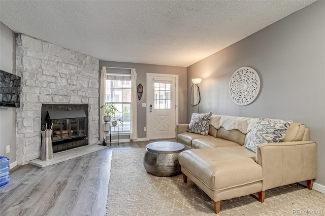 1068 Milo Cir Unit A, Lafayette, CO 80026 - living room featuring wood finished floors, a textured ceiling, and a fireplace