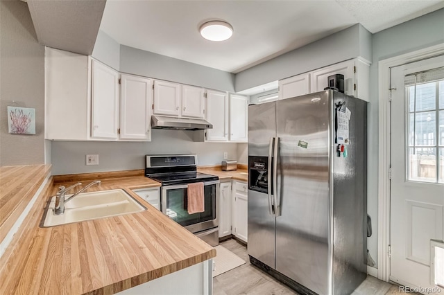 1068 Milo Cir Unit A, Lafayette, CO 80026 - kitchen with appliances with stainless steel finishes, under cabinet range hood, white cabinets, and light wood-style flooring