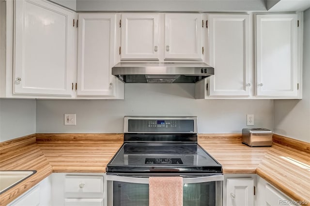 1068 Milo Cir Unit A, Lafayette, CO 80026 - kitchen with electric stove, under cabinet range hood, white cabinetry, and butcher block counters