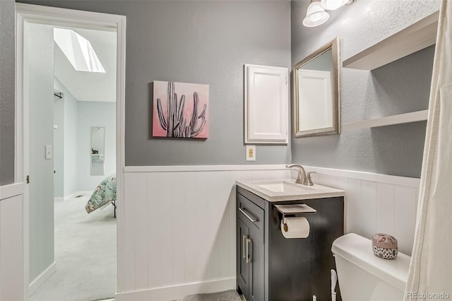 1068 Milo Cir Unit A, Lafayette, CO 80026 - bathroom featuring vanity, a wainscoted wall, and a skylight