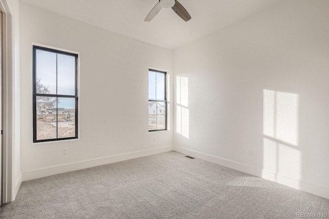 unfurnished room featuring ceiling fan and light carpet