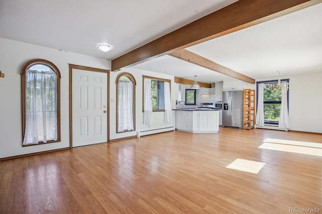 5939 S Skyline Dr, Evergreen, CO 80439 - foyer entrance featuring a baseboard heating unit, light wood-style flooring, and beam ceiling