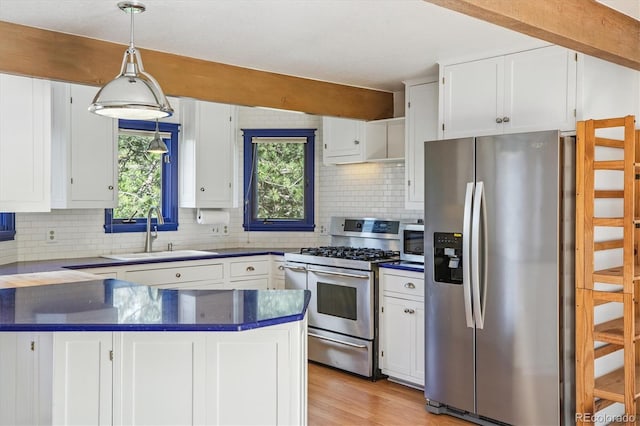 5939 S Skyline Dr, Evergreen, CO 80439 - kitchen featuring stainless steel appliances, dark countertops, a peninsula, and white cabinetry