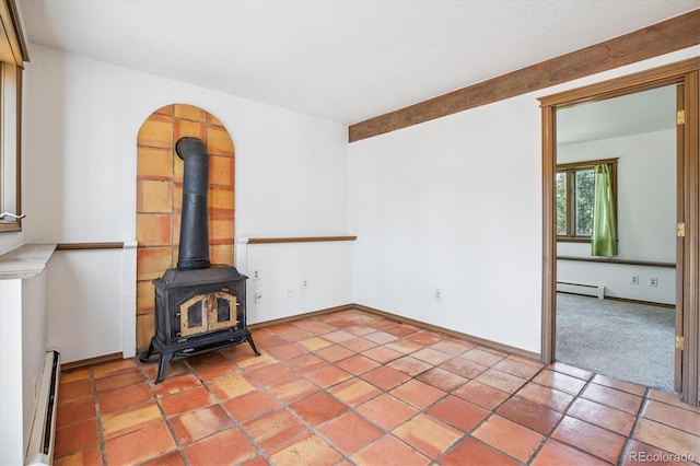 5939 S Skyline Dr, Evergreen, CO 80439 - unfurnished living room featuring baseboard heating, a wood stove, and light tile patterned flooring