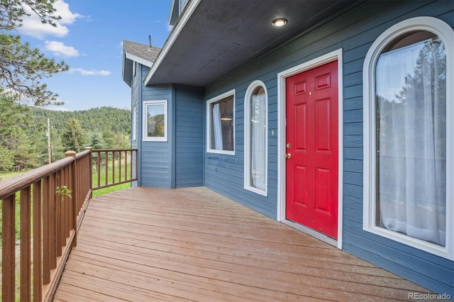 5939 S Skyline Dr, Evergreen, CO 80439 - wooden deck featuring a forest view