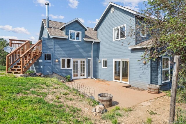 5939 S Skyline Dr, Evergreen, CO 80439 - back of property with french doors, stairway, a patio area, roof with shingles, and a deck