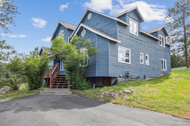 5939 S Skyline Dr, Evergreen, CO 80439 - view of side of property with a deck and a lawn