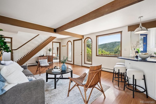 5939 S Skyline Dr, Evergreen, CO 80439 - living area featuring a baseboard heating unit, light wood-style flooring, stairs, beamed ceiling, and baseboard heating