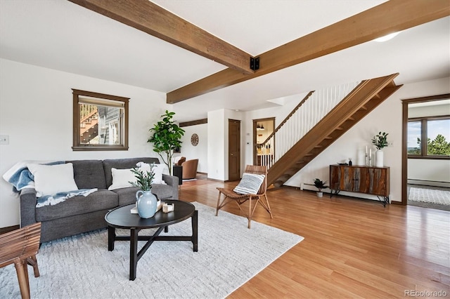5939 S Skyline Dr, Evergreen, CO 80439 - living room featuring light wood finished floors, stairway, a baseboard heating unit, and beamed ceiling