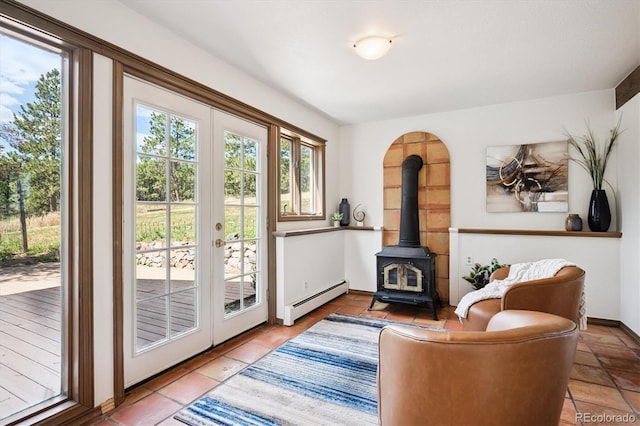 5939 S Skyline Dr, Evergreen, CO 80439 - living area with baseboard heating, a wood stove, and tile patterned flooring
