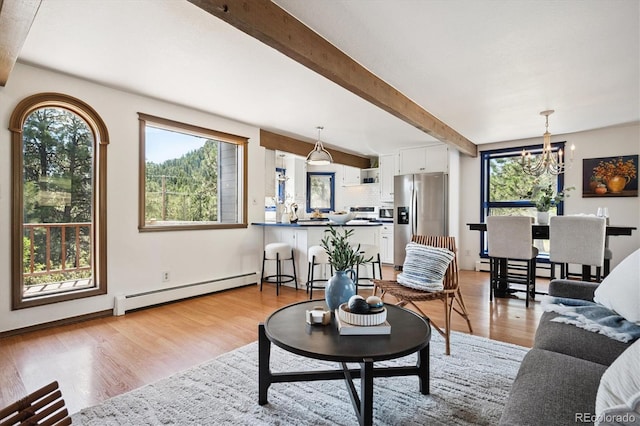 5939 S Skyline Dr, Evergreen, CO 80439 - living room featuring a baseboard radiator, beamed ceiling, a chandelier, and light wood-style flooring