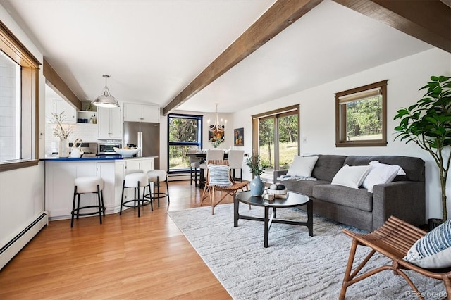 5939 S Skyline Dr, Evergreen, CO 80439 - living area with a baseboard heating unit, beamed ceiling, light wood finished floors, and a chandelier