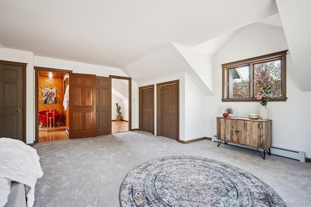 5939 S Skyline Dr, Evergreen, CO 80439 - bedroom with light carpet, vaulted ceiling, multiple closets, and baseboard heating