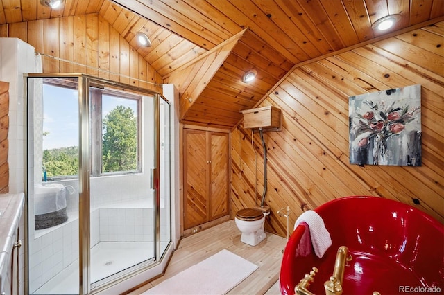 5939 S Skyline Dr, Evergreen, CO 80439 - full bath featuring lofted ceiling, wooden walls, a freestanding tub, wood finished floors, and a shower stall