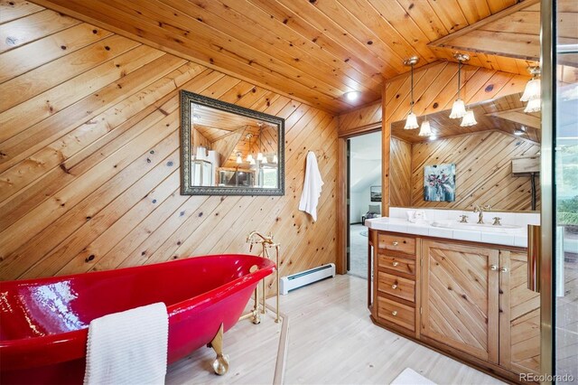 5939 S Skyline Dr, Evergreen, CO 80439 - full bath with a baseboard heating unit, a freestanding tub, vanity, vaulted ceiling, and wooden walls
