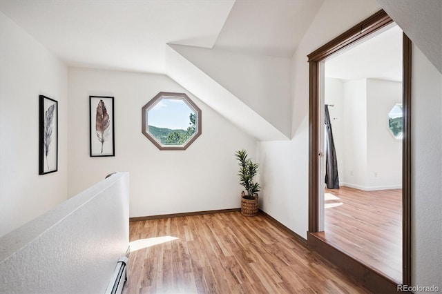 5939 S Skyline Dr, Evergreen, CO 80439 - corridor featuring light wood-style flooring, lofted ceiling, and a baseboard radiator