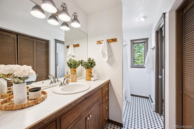 5939 S Skyline Dr, Evergreen, CO 80439 - full bath with a closet, vanity, tile patterned floors, and a baseboard radiator