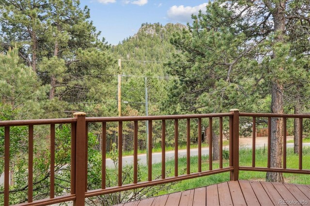 5939 S Skyline Dr, Evergreen, CO 80439 - wooden deck with a view of trees