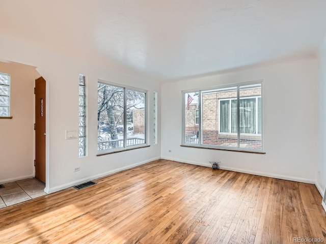 spare room with light hardwood / wood-style flooring