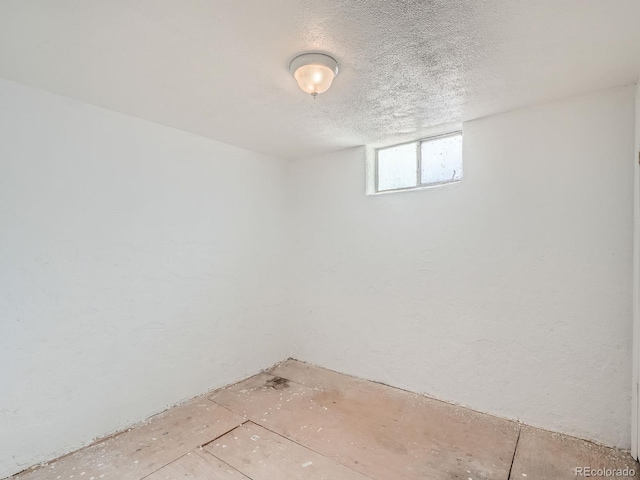 basement featuring a textured ceiling