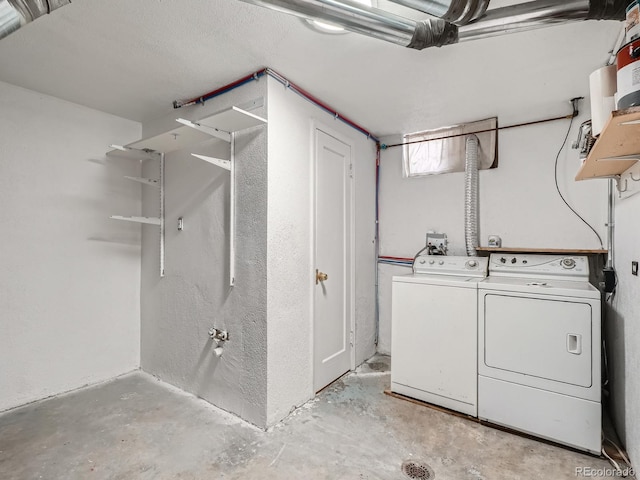 clothes washing area with washing machine and clothes dryer