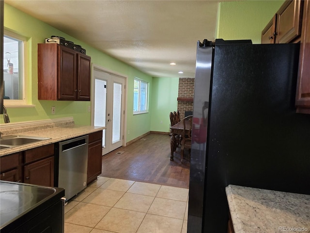 kitchen featuring light wood-type flooring, sink, stainless steel appliances, and french doors