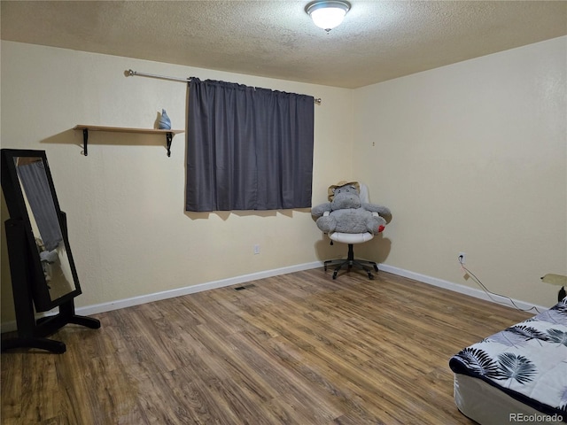 unfurnished bedroom with a textured ceiling and hardwood / wood-style floors