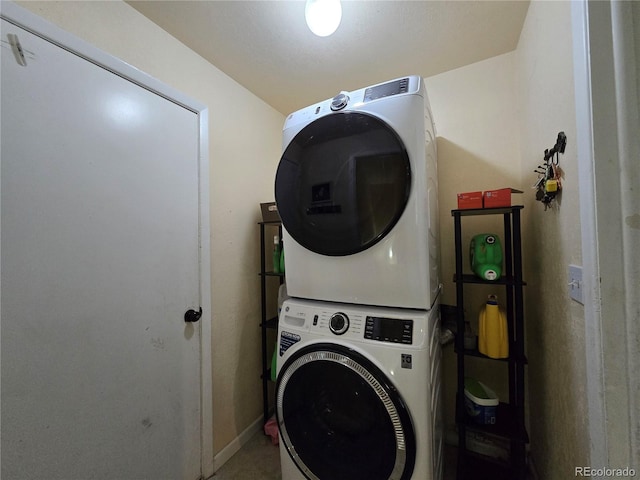 laundry room with stacked washer / dryer