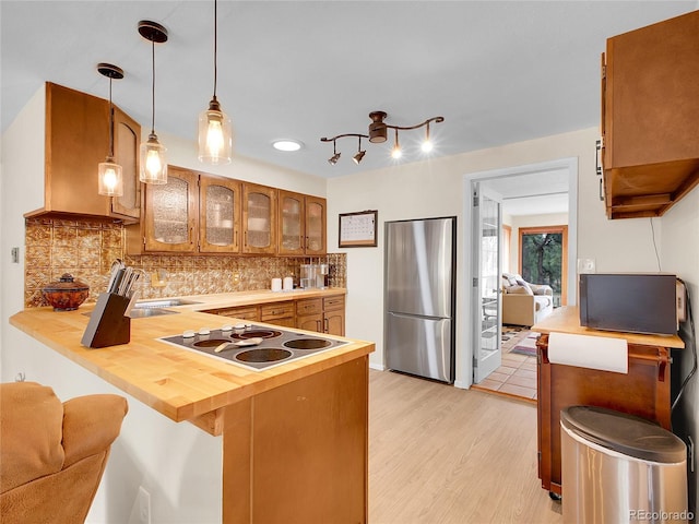 194 Tincup Ter, Bailey, CO 80421 - kitchen with freestanding refrigerator, electric stovetop, a peninsula, glass insert cabinets, and a breakfast bar area