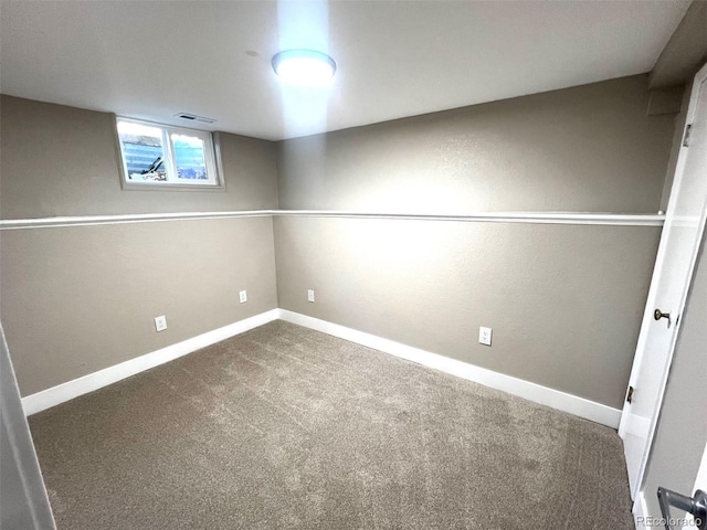 basement featuring dark carpet