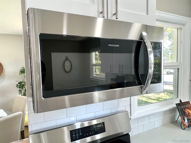 details with white cabinets and appliances with stainless steel finishes