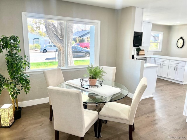 dining space featuring wood-type flooring