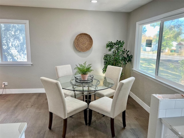 dining area with light wood-type flooring and plenty of natural light