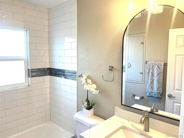 full bathroom featuring vanity, toilet, and tiled shower / bath combo