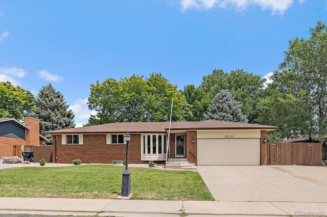 2130 Squires St, Longmont, CO 80501 - ranch-style home featuring a garage, brick siding, and driveway