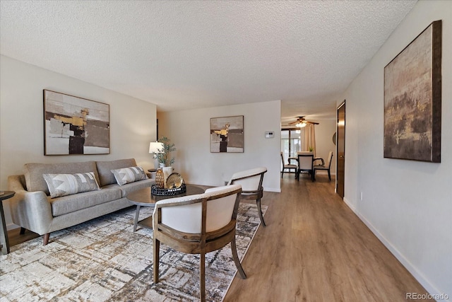 2130 Squires St, Longmont, CO 80501 - living room with wood finished floors, a textured ceiling, and ceiling fan
