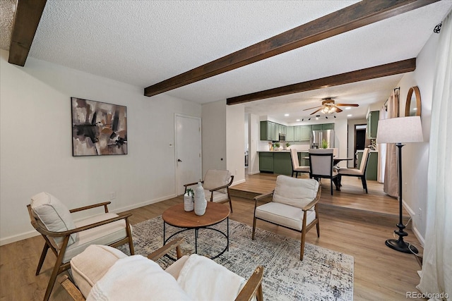 2130 Squires St, Longmont, CO 80501 - living area featuring beamed ceiling, ceiling fan, a textured ceiling, and light wood-style floors